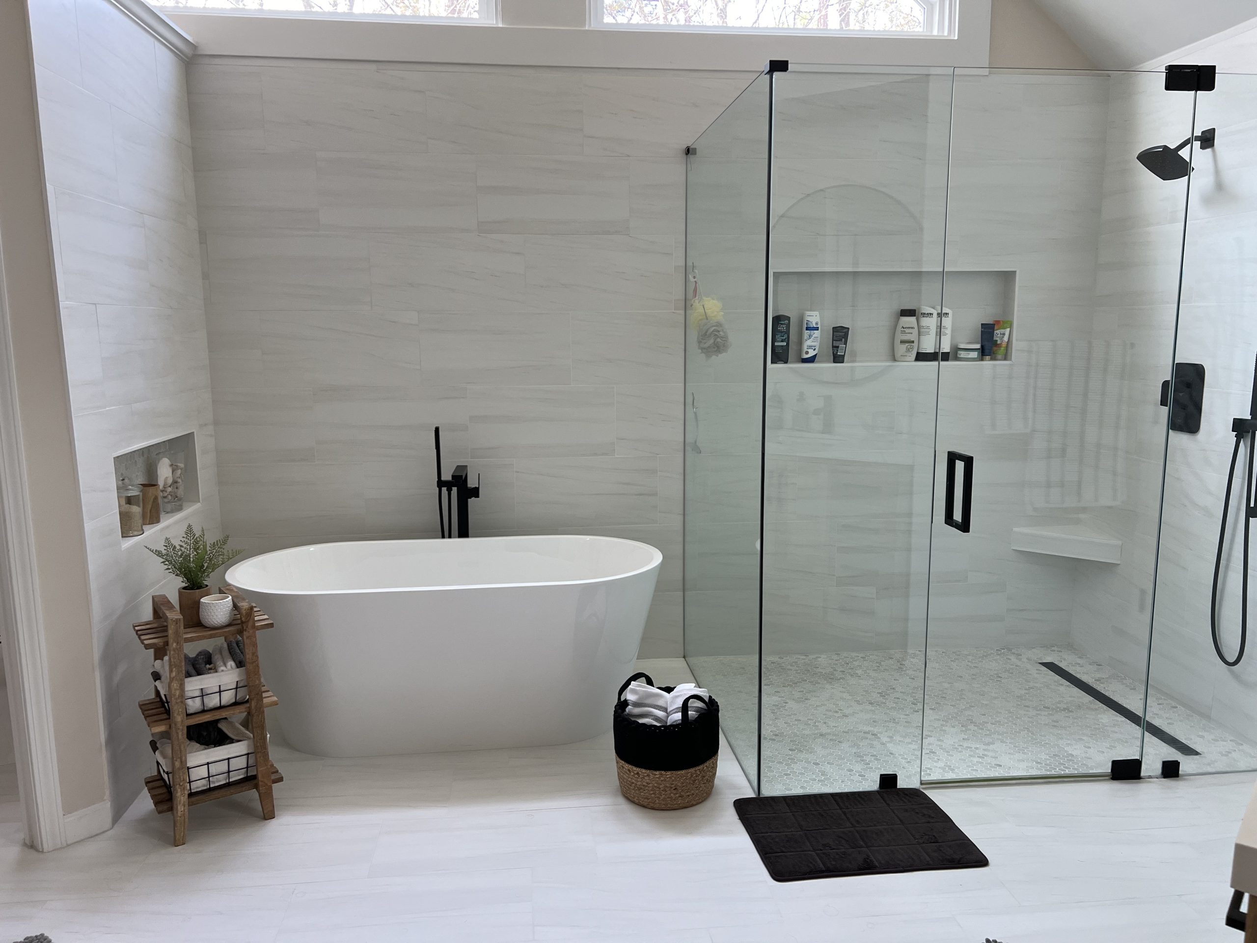 Full bathroom remodel with a freestanding tub and a glass-enclosed curbless shower