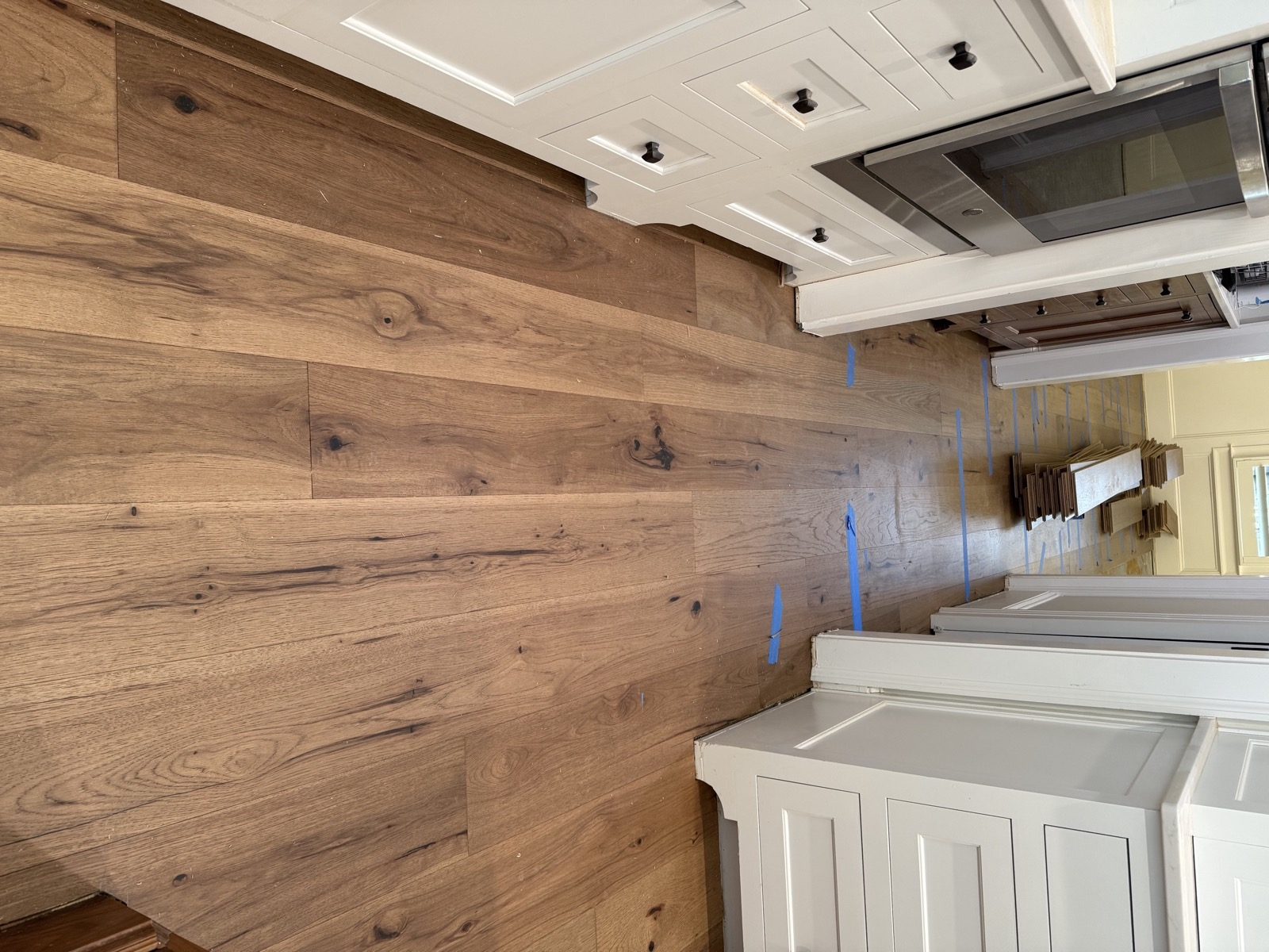 Wide-plank hardwood flooring installed through a kitchen in an Alpharetta GA home