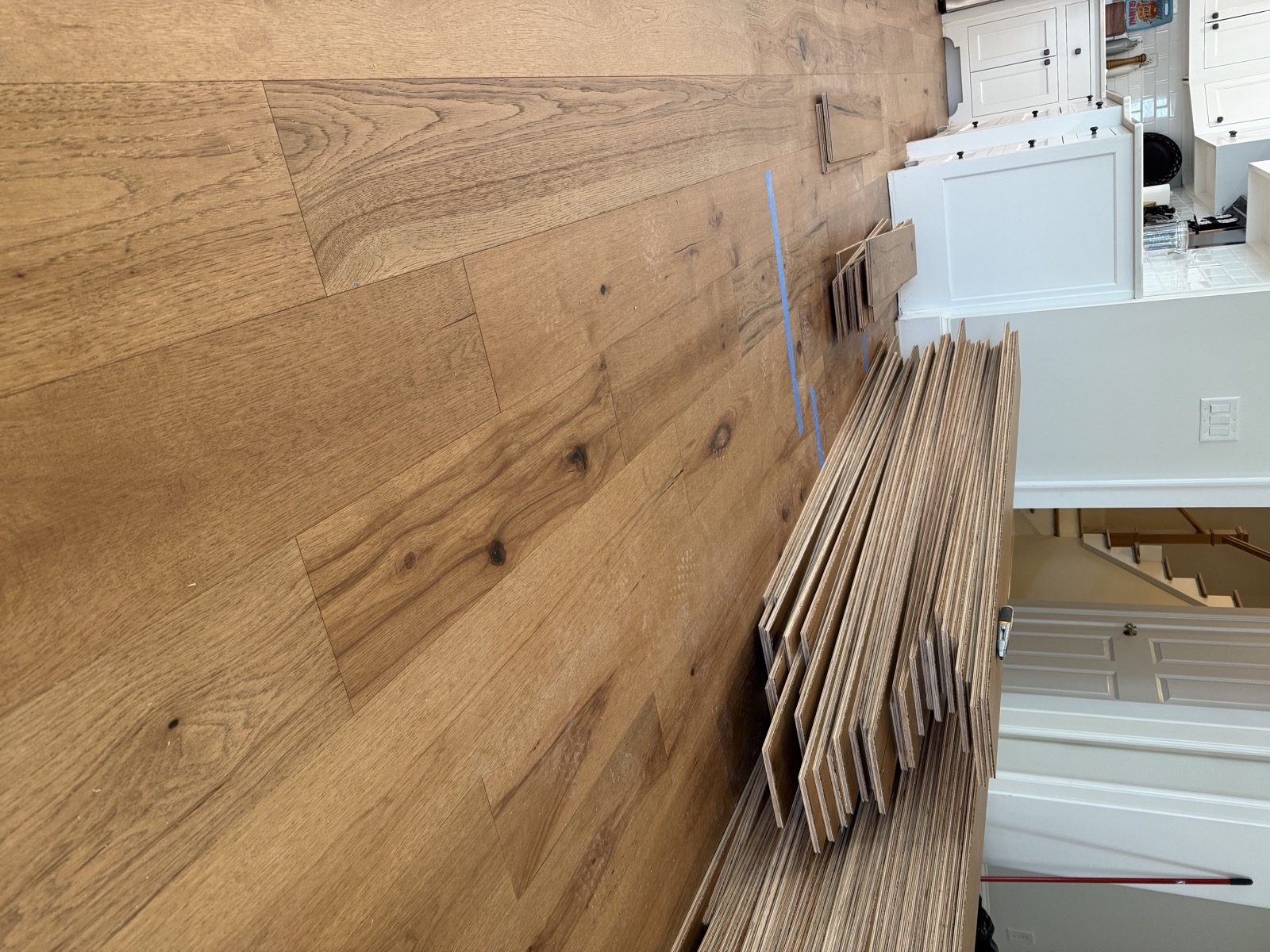 Wide-plank hardwood flooring being installed where carpet was removed in an Alpharetta GA home